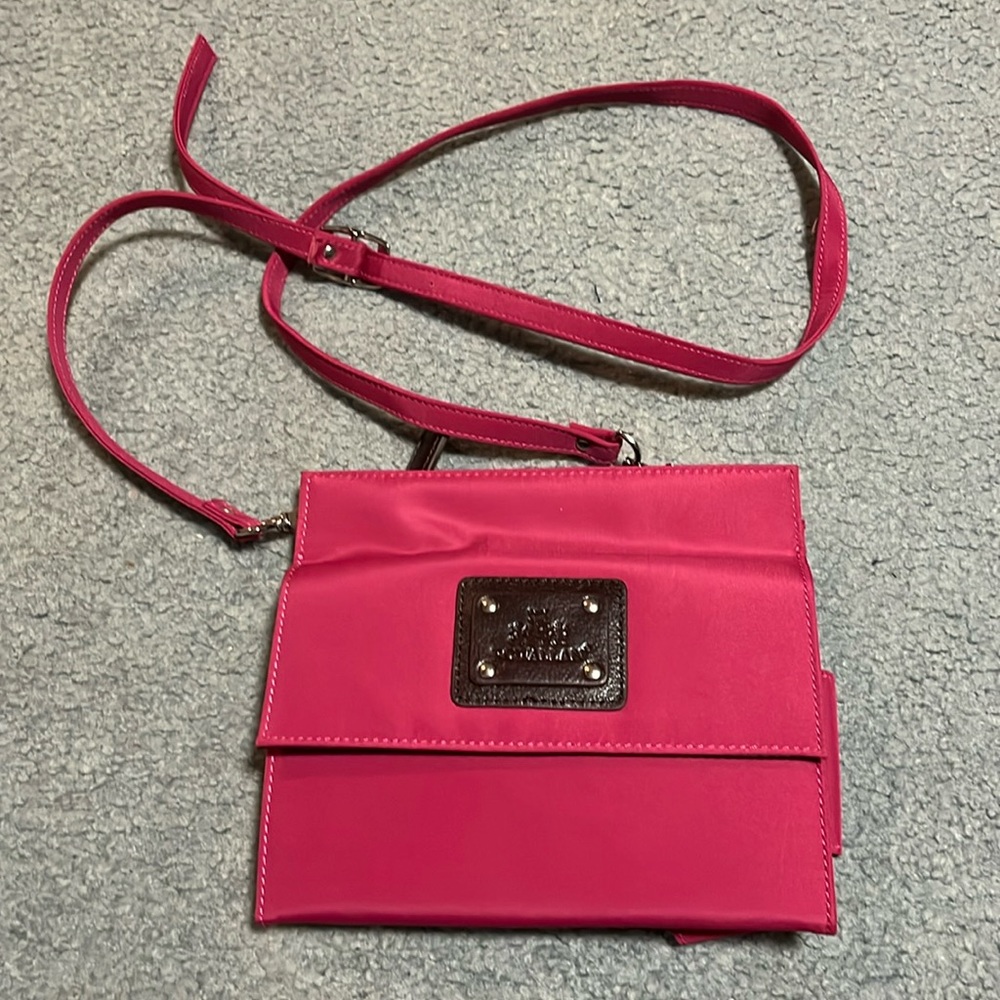 Pink multiple compartment cross body bag.
